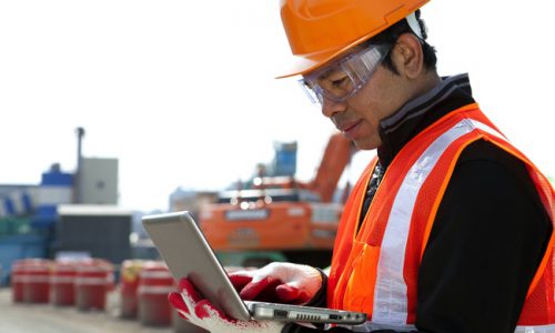 Construction worker using laptop